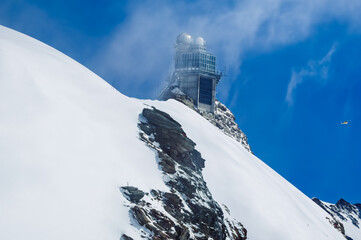 Aerial Wonders: Helicopter Soaring Near the Jungfraujoch Sphinx Observatory