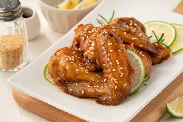 Honey Lemon Glazed Chicken Wings with Sesame and Lime.