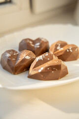 Polygonal heart chocolates on plate