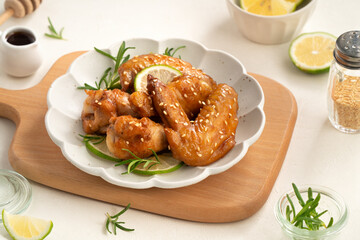 Honey Lemon Glazed Chicken Wings with Sesame and Lime.