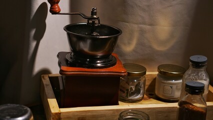 View of vintage coffee grinder and beans on countertop in kitchen. Coffee brew. Mill