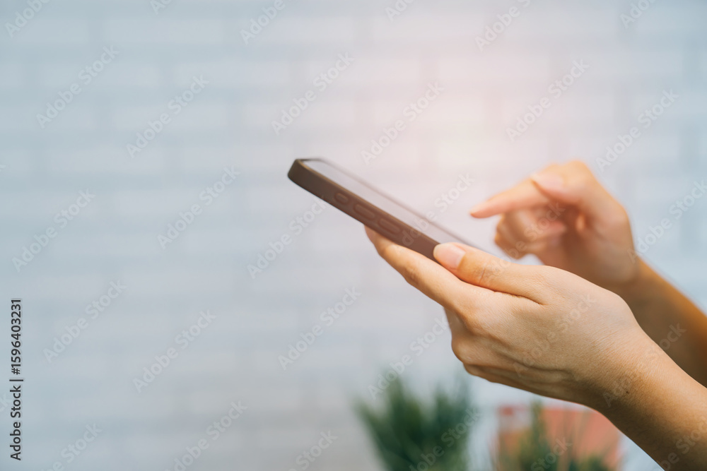 Poster hands using smartphone with soft lighting in background