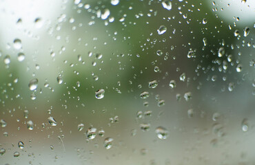 Natural large and fine water drops on glass