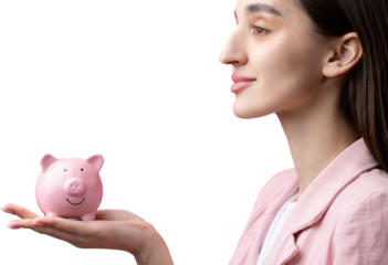 A cute girl in a pink jacket is holding a 3d piggy bank in her hands. Beautiful close-up portrait in studio on pink.