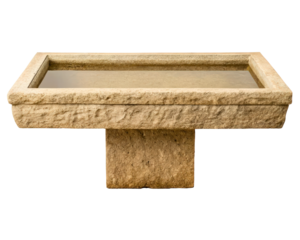 Rectangular hand-carved stone bird bath filled with water on a transparent background