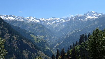 Obraz premium Serene mountain landscape with snow-capped peaks, green valleys, and a clear blue sky in natural harmony