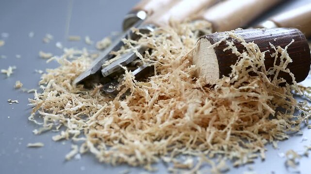 Carpentry tools with wood shavings on table