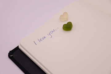 I love you written on a white page of a notebook, valentine concept