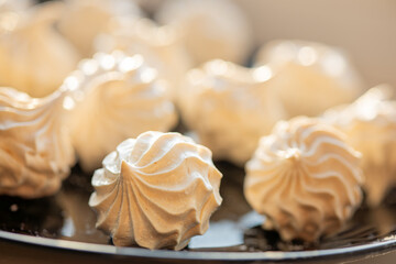 Meringue cookies on black plate
