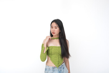 Worried young Asian woman looking down in sadness