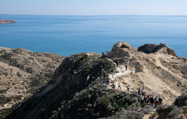 Group of people trekking in nature on a hiking trail. Healthy lifestyle. Exercising outdoor.