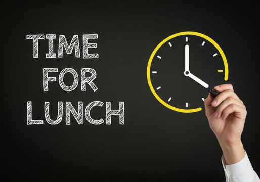 Chalkboard drawing of a clock indicating time for lunch