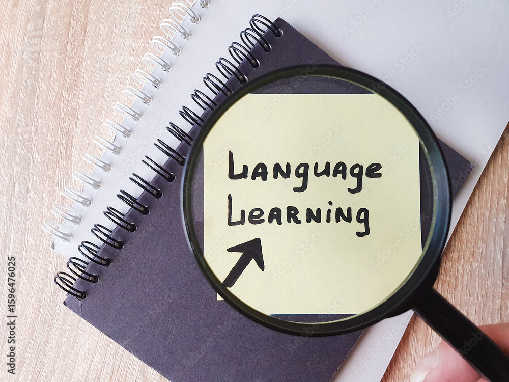 Fototapete language learning, text note note taking on a sheet of paper through a magnifying glass. language le