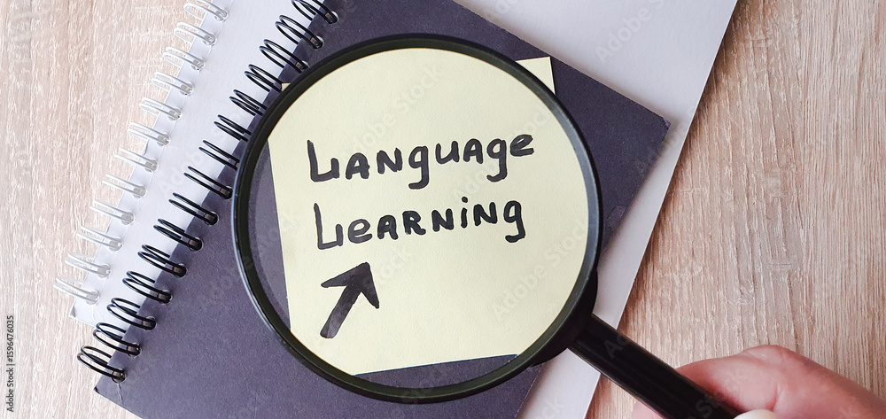 Fototapete language learning, text note note taking on a sheet of paper through a magnifying glass. language le