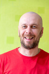 A man poses against a wall, making various grimaces