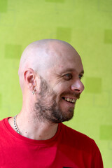 A man poses against a wall, making various grimaces