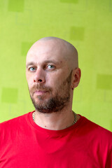 A man poses against a wall, making various grimaces