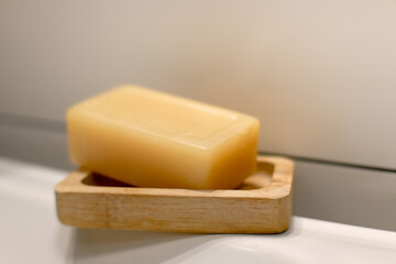 A bar of gray soap on the edge of the sink, hygiene.
