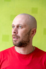 A man poses against a wall, making various grimaces