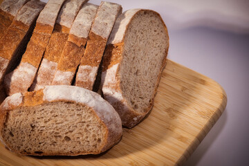 Freshly Baked Whole Wheat Bread Slices on a Wooden Cutting Board