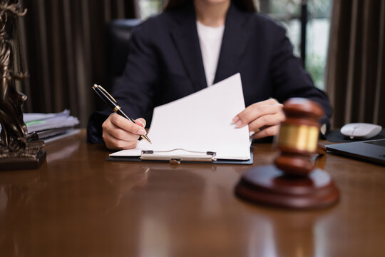 Lawyer Businesswoman Working with Documents and Signing Contract at Office Desk, Hammer on Wood table, Judge's Gavel, Law, Justice Symbol,