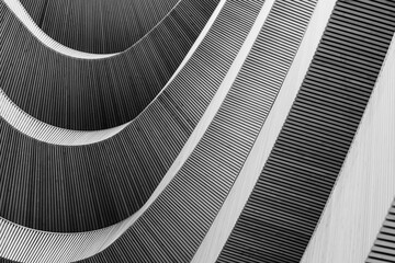 Abstract Architectural Detail of Curved Wooden Slats Creating Modern Rhythmic Patterns in Black and...
