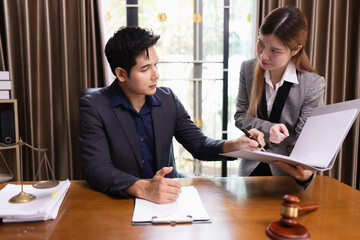 Two Lawyer with Document Paper and Hammer on Wood table,  Judge's Gavel, Law, Justice Symbol, Agreement and Partnership Concept,