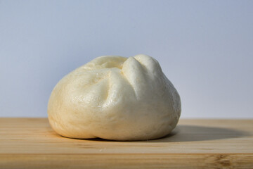 Delicious Steamed Bun on a Wooden Surface