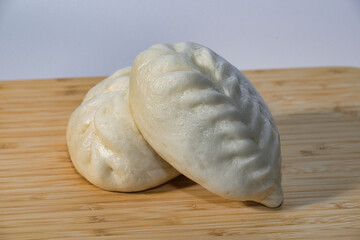 Delicious Steamed Buns on a Bamboo Cutting Board