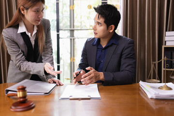 Two Lawyer with Document Paper and Hammer on Wood table,  Judge's Gavel, Law, Justice Symbol, Agreement and Partnership Concept,