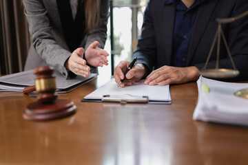 Two Lawyer with Document Paper and Hammer on Wood table, Judge's Gavel, Law, Justice Symbol, Agreement and Partnership Concept,