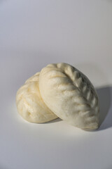 Two Freshly Made Steamed Buns on a White Background