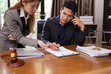 Two Lawyer with Document Paper and Hammer on Wood table,  Judge's Gavel, Law, Justice Symbol, Agreement and Partnership Concept,