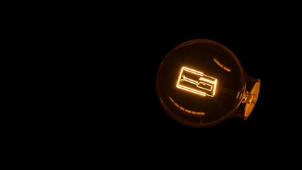 Abstract glowing light bulb symbolizing innovation against a dark atmospheric backdrop.