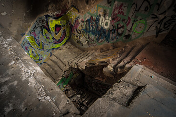 Dilapidated stairwell in an abandoned Berlin brewery covered with colorful graffiti and debris,...