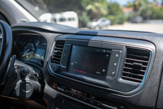 Modern Car Interior With Touchscreen Display Showcasing Audio Controls and Dashboard Features in a Sunny Outdoor Setting