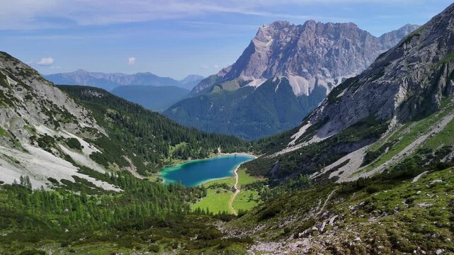 Aerial drone view of the Alps mountains, with Coburger H&uuml;tte located near the scenic lakes Seebensee and Drachensee on a bright, sunny summer day. People are enjoying a beautiful view.