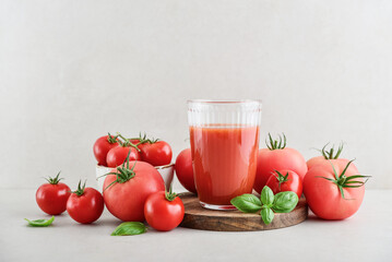 Tomato juice in a glass and fresh tomatoes