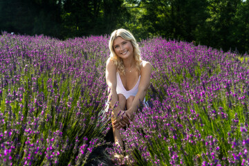 lavender field, flowers, nature, outdoors, summer, sunlight, joyful, greenery, purple, relaxation with lush greenery framing the background. The bright sunlight accentuates 