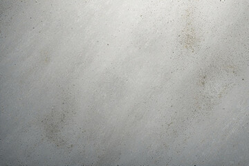 Gray concrete wall texture background with speckles and pores.