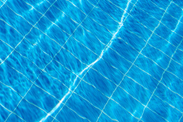 Clear Blue Water Reflecting Sunlight With Grid Pattern Visible Below Surface in a Swimming Pool on...