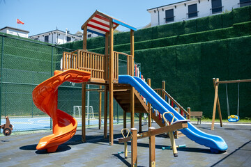 Colorful Playground Equipment Featuring Slides and Climbing Structures in a Sunny Outdoor Setting