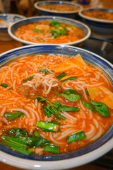 Delicious Red Soup Rice Noodles with Tasty Ingredients and Fresh Vegetables
