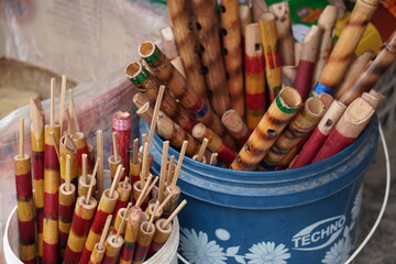 A collection of Bansuris made by bamboo are displayed for sale in a market