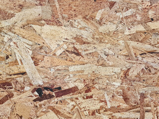Background of abstract texture board surface of wood chips for decoration. Oriented Strand Board (OSB) is a type of structural composite board made of cross-linked wood strands glued and then pressed.
