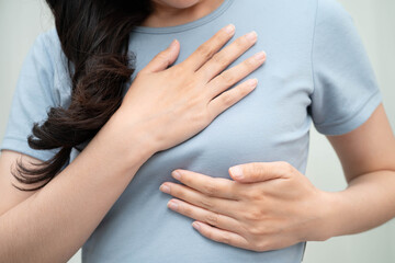 Asian woman self touching check lump or Breast cancer, Breast Self Exam.