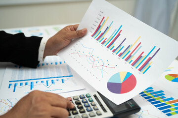 Asian business woman working with financial graph.