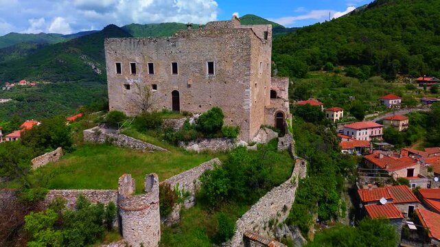 Aerial view of the ruins of an ancient castle, a medieval village on a hill near the Neva River valley and built for defensive purposes, history. Castelvecchio di Rocca Barbena Savona Italy 01.09.2025