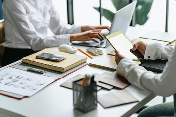Interior designer discussing wood laminate materials in modern office