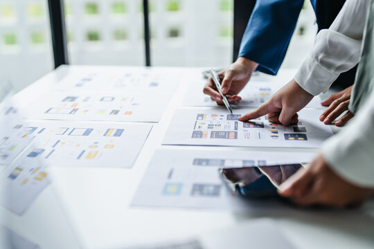 UI designer and UX specialist collaborating on digital prototypes in brainstorm